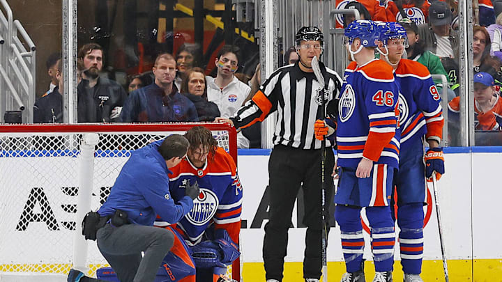 Mar 26, 2025; Edmonton, Alberta, CAN; Edmonton Oilers goaltender Stuart Skinner (74) is tended to by medical staff after being hit in the head with a knee from Dallas Stars forward forward Mikko Rantanen (96) during the third period at Rogers Place. Mandatory Credit: Perry Nelson-Imagn Images