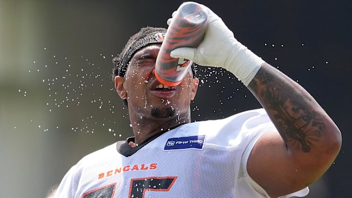 Jul 26, 2024; Cincinnati, OH, USA; Cincinnati Bengals offensive tackle Orlando Brown Jr. (75) cools off with water during training camp practice at Kettering Health Practice Fields. Mandatory Credit: Kareem Elgazzar-Imagn Images