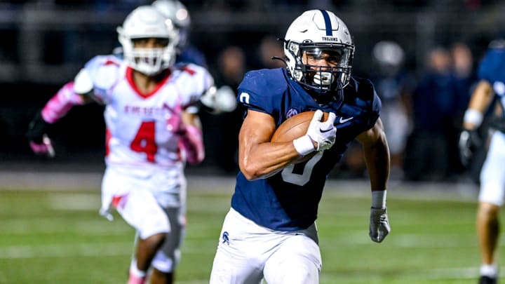East Lansing's Jace Clarizio runs for a touchdown against Everett during the second quarter on Friday, Oct. 27, 2023, in East Lansing. East Lansing's Jace Clarizio runs for a touchdown against Everett during the second quarter on Friday, Oct. 27, 2023, in East Lansing.