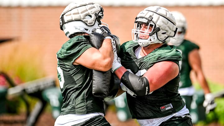 Michigan State's Ashton Lepo, right, and Charlton Luniewski run an offensive line drill during the first day of football camp on Tuesday, July 30, 2024, in East Lansing.