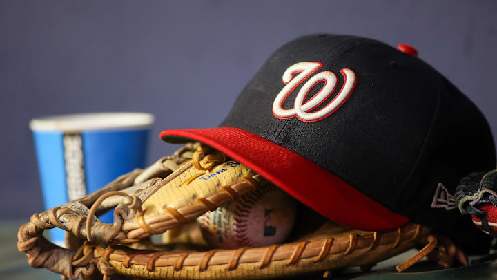 Sep 29, 2023; Atlanta, Georgia, USA; A detailed view of a Washington Nationals hat and glove on the bench against the Atlanta Braves in the third inning at Truist Park. Mandatory Credit: Brett Davis-Imagn Images