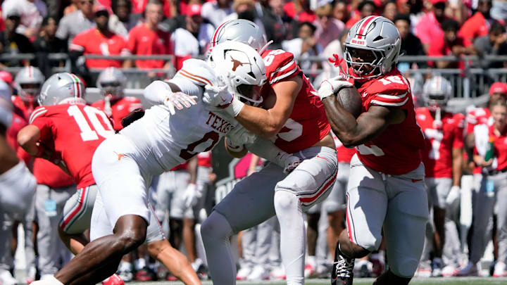 Ohio State Buckeyes running back CJ Donaldson (12) carries the ball against Texas Longhorns in the second quarter of their game at Ohio Stadium in Columbus, Ohio on Aug 30, 2025.