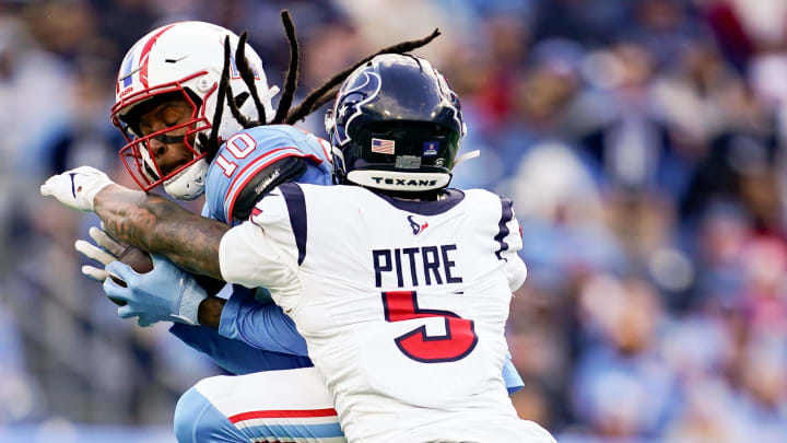 Houston Texans safety Jalen Pitre (5) breaks up a pass intended for Tennessee Titans wide receiver DeAndre Hopkins (10) during the third quarter at Nissan Stadium in Nashville, Tenn., Sunday, Dec. 17, 2023.