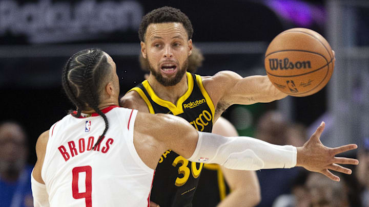 Golden State Warriors guard Stephen Curry (30) passes against Houston Rockets guard Dillon Brooks (9) during the third quarter at Chase Center. Mandatory Credit: D. Ross Cameron-Imagn Images
