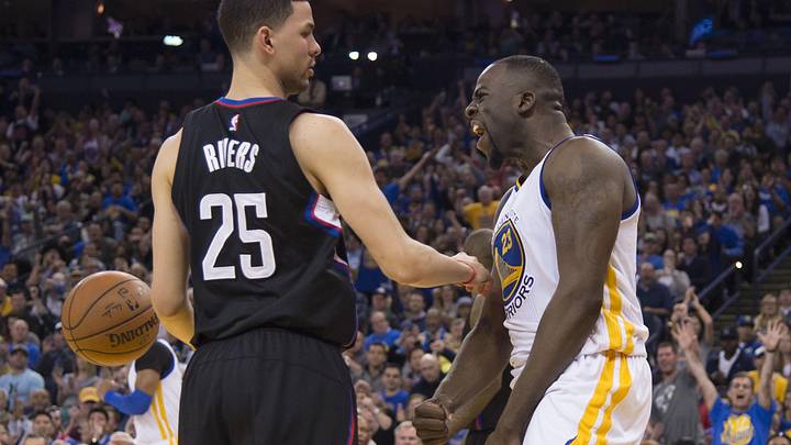 March 23, 2016; Oakland, CA, USA; Golden State Warriors forward Draymond Green (23) celebrates against Los Angeles Clippers guard Austin Rivers (25) during the third quarter at Oracle Arena. The Warriors defeated the Clippers 114-98. Mandatory Credit: Kyle Terada-Imagn Images
