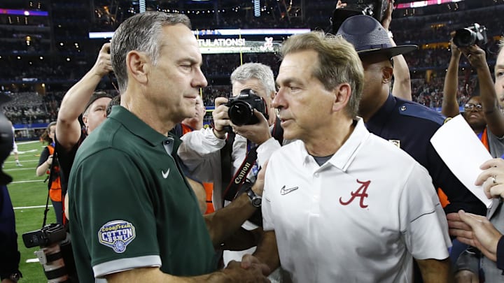 Dec 31, 2015; Arlington, TX, USA; Michigan State Spartans head coach Mark Dantonio (left) and Alabama Crimson Tide head coach Nick Saban (right) shake hands after the 2015 CFP semifinal at the Cotton Bowl at AT&T Stadium. Mandatory Credit: Tim Heitman-Imagn Images
