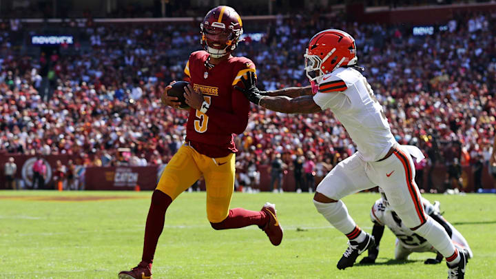 Washington Commanders quarterback Jayden Daniels (5) is pushed out of bounds by Cleveland Browns safety Grant Delpit (9) during the first quarter at NorthWest Stadium.