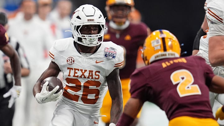 Jan 1, 2025; Atlanta, GA, USA; Texas Longhorns running back Quintrevion Wisner (26) runs with the ball against the Texas Longhorns during the first half of the Peach Bowl at Mercedes-Benz Stadium. Mandatory Credit: Dale Zanine-Imagn Images