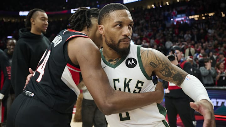Jan 31, 2024; Portland, Oregon, USA; Milwaukee Bucks guard Damian Lillard (0) embraces Portland Trail Blazers forward Jabari Walker (34) after a game at Moda Center. Mandatory Credit: Troy Wayrynen-USA TODAY Sports