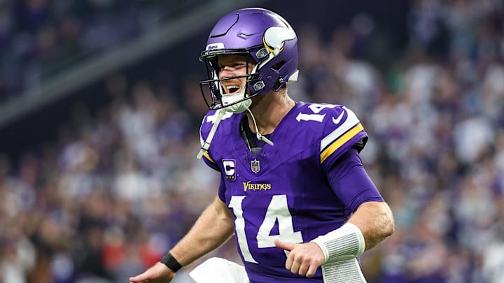 Dec 8, 2024; Minneapolis, Minnesota, USA; Minnesota Vikings quarterback Sam Darnold (14) celebrates running back Aaron Jones' (33) touchdown run against the Atlanta Falcons during the fourth quarter at U.S. Bank Stadium. Mandatory Credit: Matt Krohn-Imagn Images