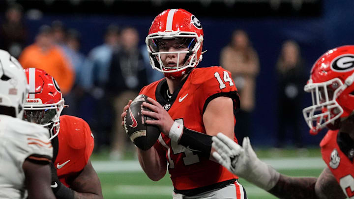 Georgia quarterback Gunner Stockton (14) looks to throw a pass during overtime of the SEC championship game against Texas in Atlanta, on Saturday, Dec. 7, 2024. Georgia quarterback Gunner Stockton (14) looks to throw a pass during overtime of the SEC championship game against Texas in Atlanta, on Saturday, Dec. 7, 2024.