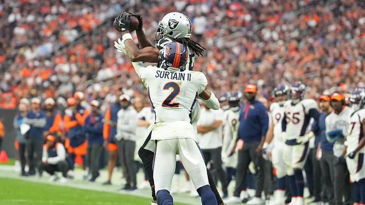 Oct 2, 2022; Paradise, Nevada, USA; Las Vegas Raiders wide receiver Davante Adams (17) makes a catch against Denver Broncos cornerback Pat Surtain II (2) during a game at Allegiant Stadium. Mandatory Credit: Stephen R. Sylvanie-Imagn Images