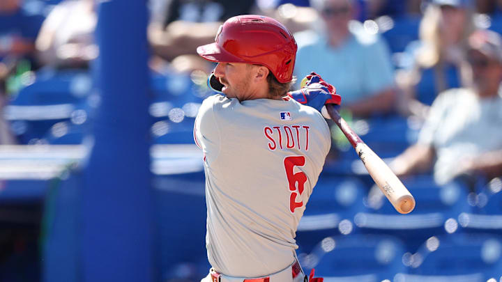 Feb 26, 2025; Dunedin, Florida, USA; Philadelphia Phillies second base Bryson Stott (5) hits an rbi single against the Toronto Blue Jays in the sixth inning during spring training at TD Ballpark.