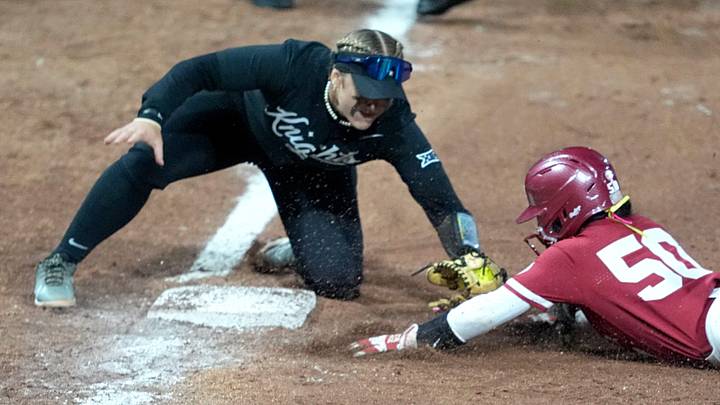 Oklahoma's Ailana Agbayani (50) is tagged out by UCF's Aubrey Evans (3) during the college softball game between the University of Oklahoma Sooners and the UCF Knights at Love's Field in Norman, Okla., Friday, April, 4, 2025. Oklahoma's Ailana Agbayani (50) is tagged out by UCF's Aubrey Evans (3) during the college softball game between the University of Oklahoma Sooners and the UCF Knights at Love's Field in Norman, Okla., Friday, April, 4, 2025.