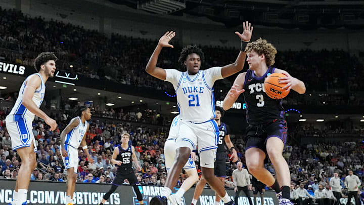 Mar 21, 2026; Greenville, SC, USA; Texas Christian University Horned Frogs guard Liutauras Lelevicius (3) drives to the basket against Duke Blue Devils center Patrick Ngongba (21) during the first half during a second round game of the men's 2026 NCAA Tournament at Bon Secours Wellness Arena.