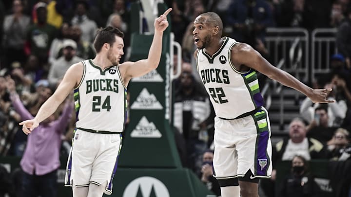 Dec 1, 2021; Milwaukee, Wisconsin, USA;  Milwaukee Bucks forward Khris Middleton (22) reacts with guard Pat Connaughton (24) after hitting a three-point basket late in the fourth quarter during the game against the Charlotte Hornets at Fiserv Forum. Mandatory Credit: Benny Sieu-Imagn Images