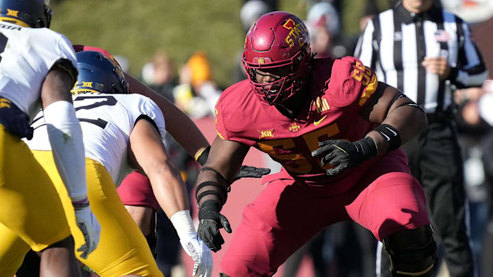Iowa State offensive lineman Darrell Simmons, Jr., (55) blocks in the first quarter against West Virginia