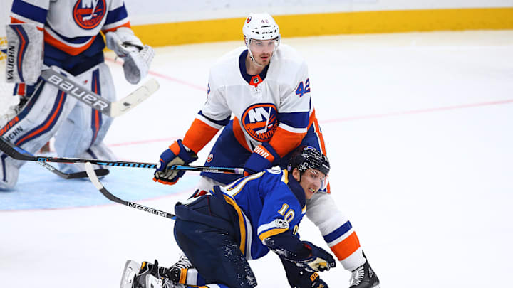Nov 11, 2017; St. Louis, MO, USA; St. Louis Blues center Brayden Schenn (10) is shoved to the ice by New York Islanders defenseman Scott Mayfield (42) as they battle for position during the third period at Scottrade Center. The Islanders won 5-2. Mandatory Credit: Billy Hurst-Imagn Images