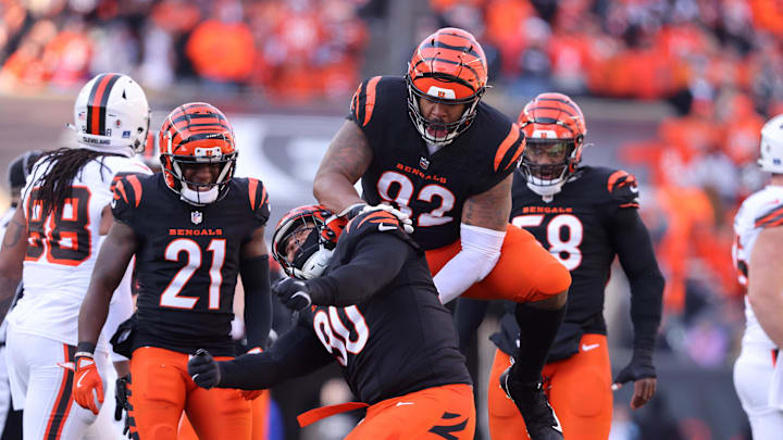 Dec 22, 2024; Cincinnati, Ohio, USA;  Cincinnati Bengals defensive tackle B.J. Hill (92) celebrates a sack with defensive tackle Kris Jenkins Jr. (90) during the first quarter against the Cleveland Browns at Paycor Stadium. Mandatory Credit: Joseph Maiorana-Imagn Images