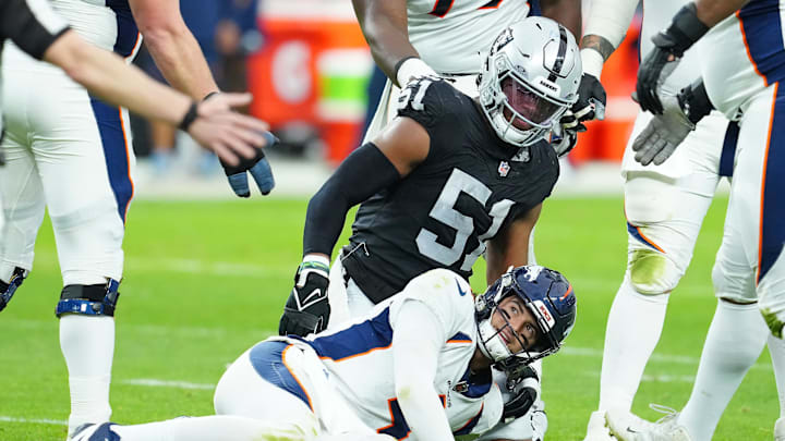 Jan 7, 2024; Paradise, Nevada, USA; Denver Broncos quarterback Jarrett Stidham (4) reacts after being knocked down by Las Vegas Raiders defensive end Malcolm Koonce (51) during the second quarter at Allegiant Stadium. Mandatory Credit: Stephen R. Sylvanie-Imagn Images