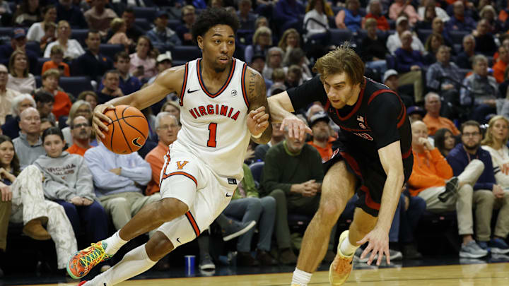 Jan 10, 2026; Charlottesville, Virginia, USA; Virginia Cavaliers guard Malik Thomas (1) drives to the basket past Stanford Cardinal forward Cameron Grant (20) in the second half at John Paul Jones Arena. Mandatory Credit: Geoff Burke-Imagn Images
