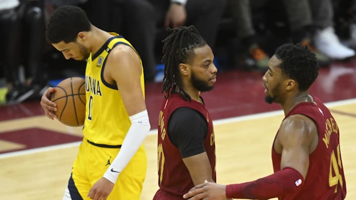Apr 12, 2024; Cleveland, Ohio, USA; Indiana Pacers guard Tyrese Haliburton (0) and Cleveland Cavaliers guard Donovan Mitchell (45) react after a three-point basket by guard Darius Garland (10) in the fourth quarter at Rocket Mortgage FieldHouse. Mandatory Credit: David Richard-Imagn Images