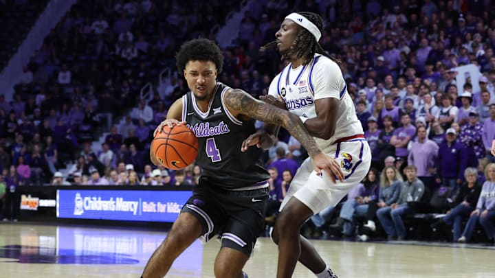 Jan 24, 2026; Manhattan, Kansas, USA; Kansas State Wildcats guard P.J. Haggerty (4) is gaurded by Kansas Jayhawks guard Jamari McDowell (11) during the first half at Bramlage Coliseum. 
