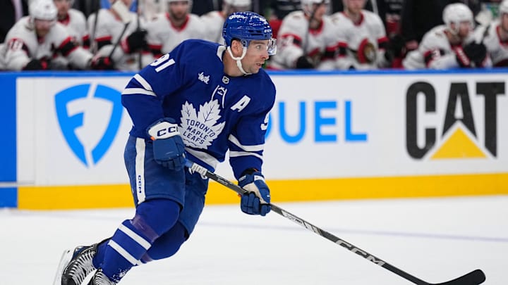Apr 20, 2025; Toronto, Ontario, CAN; Toronto Maple Leafs forward John Tavares (91) carries the puck against the Ottawa Senators during the second period of game one of the first round of the 2025 Stanley Cup Playoffs at Scotiabank Arena. Mandatory Credit: John E. Sokolowski-Imagn Images
