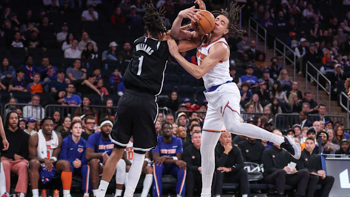 Nov 9, 2025; New York, New York, USA;  Brooklyn Nets forward Ziaire Williams (1) and New York Knicks forward Pacome Dadiet (4) fight for a loose ball in the fourth quarter at Madison Square Garden. Mandatory Credit: Wendell Cruz-Imagn Images
