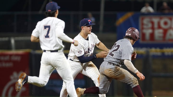 University of Mississippi baseball players Luke Hill (7) and Judd Utermark (27) attempt to tag Ross Highfill (22) of Mississippi State University during the Governor's Cup at Trustmark Park on April 22, 2025 in Pearl, Miss.