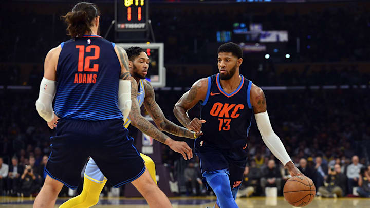 January 3, 2018; Los Angeles, CA, USA; Oklahoma City Thunder forward Paul George (13) moves the ball as center Steven Adams (12) provides coverage against Los Angeles Lakers forward Brandon Ingram (14) during the first half at Staples Center. Mandatory Credit: Gary A. Vasquez-Imagn Images
