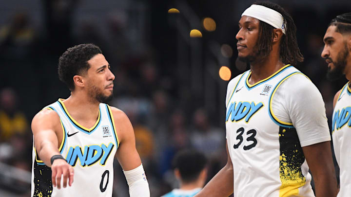 Dec 8, 2024; Indianapolis, Indiana, USA: Indiana Pacers guard Tyrese Haliburton (0) and Indiana Pacers center Myles Turner (33) talk during a timeout during the first half against the Charlotte Hornets at Gainbridge Fieldhouse. Mandatory Credit: Robert Goddin-Imagn Images 