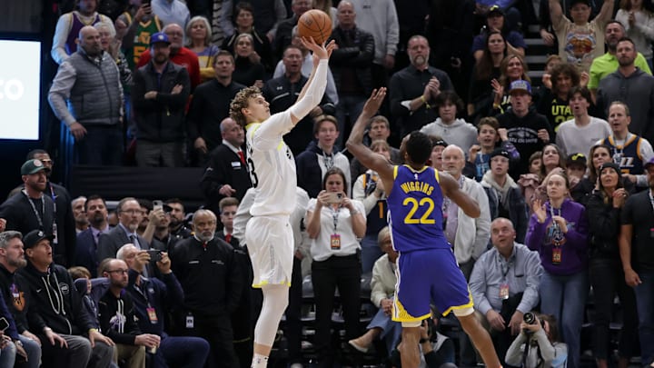 Feb 15, 2024; Salt Lake City, Utah, USA: Utah Jazz forward Lauri Markkanen (23) shoots the ball over Golden State Warriors forward Andrew Wiggins (22) during the second half at Delta Center. Mandatory Credit: Chris Nicoll-Imagn Images