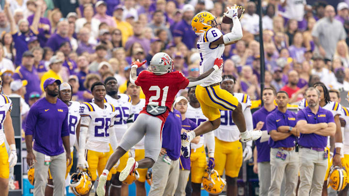 Sep 7, 2024; Baton Rouge, Louisiana, USA;  LSU Tigers wide receiver Shelton Sampson Jr. (6) catches a pass but is pushed out of bounds but Nicholls State Colonels defensive back Malik Woodery (21) during the first half at Tiger Stadium. Mandatory Credit: Stephen Lew-Imagn Images