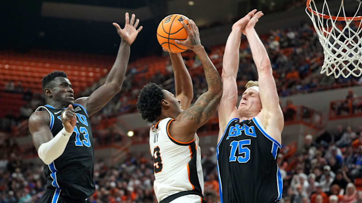 Oklahoma State Cowboys guard Anthony Roy (9) goes to the basket between BYU Cougars forward Keba Keita (13) and BYU Cougars guard Richie Saunders (15) during a BIG 12 men's college basketball game between the Oklahoma State Cowboys (OSU) and the BYU Cougars at Gallagher-Iba Arena in Stillwater, Okla., Wednesday, Feb. 4, 2026.
