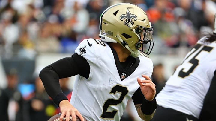 Oct 19, 2025; Chicago, Illinois, USA; New Orleans Saints quarterback Spencer Rattler (2) rushes the ball against the Chicago Bears during the second half at Soldier Field. Mandatory Credit: Mike Dinovo-Imagn Images