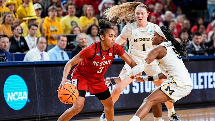 Michigan guard Brooke Q. Daniels (5) and guard Olivia Olson (1) defend N.C. State guard Zamareya Jones (3) during the second half of NCAA Tournament Second Round at Crisler Center in Ann Arbor on Sunday, March 22, 2026. Michigan guard Brooke Q. Daniels (5) and guard Olivia Olson (1) defend N.C. State guard Zamareya Jones (3) during the second half of NCAA Tournament Second Round at Crisler Center in Ann Arbor on Sunday, March 22, 2026.