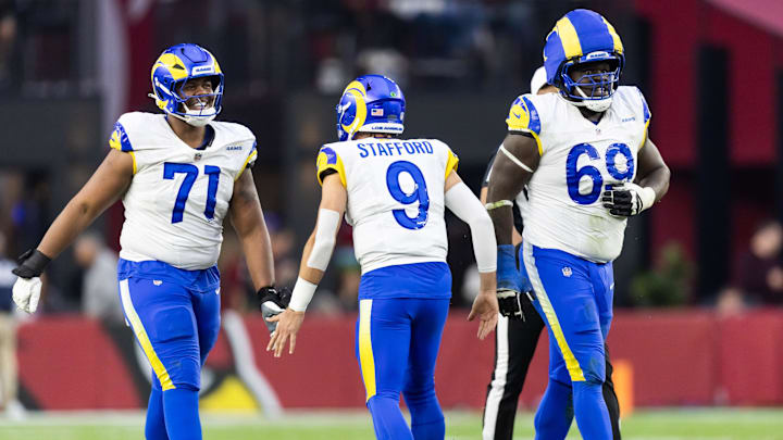 Dec 7, 2025; Glendale, Arizona, USA; Los Angeles Rams quarterback Matthew Stafford (9) celebrates a touchdown with offensive lineman Warren McClendon Jr. (71) and Kevin Dotson (69) against the Arizona Cardinals at State Farm Stadium. Mandatory Credit: Mark J. Rebilas-Imagn Images