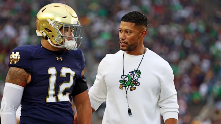 Sep 13, 2025; South Bend, Indiana, USA; Notre Dame Fighting Irish head coach Marcus Freeman reacts with Notre Dame Fighting Irish quarterback Blake Hebert (12) during the first half against the Texas A&M Aggies at Notre Dame Stadium. Mandatory Credit: Trevor Ruszkowski-Imagn Images