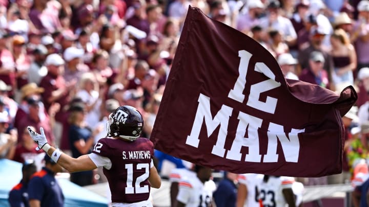 Sep 23, 2023; College Station, Texas, USA; Texas A&M Aggies linebacker Sam Mathews (12) waves the 12th Man flag during pre-game runout against the Auburn Tigers at Kyle Field. Sep 23, 2023; College Station, Texas, USA; Texas A&M Aggies linebacker Sam Mathews (12) waves the 12th Man flag during pre-game runout against the Auburn Tigers at Kyle Field.