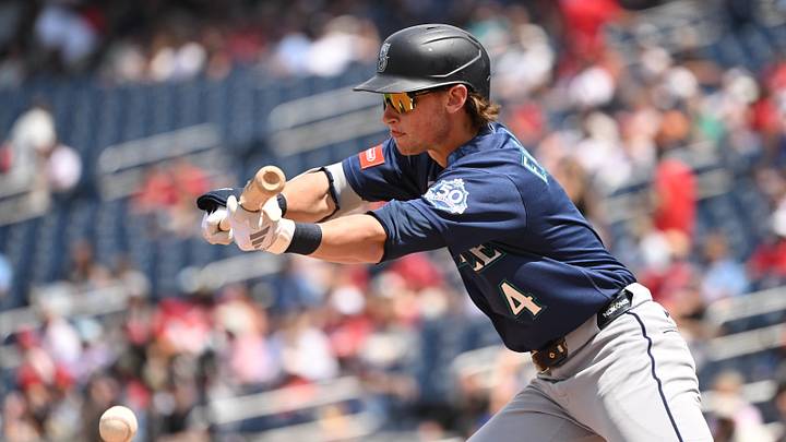 Jun 14, 2026; Washington, District of Columbia, USA; Seattle Mariners third baseman Colt Emerson (4) attempts a bunt against the Washington Nationals during the third inning at Nationals Park. Mandatory Credit: Rafael Suanes-Imagn Images