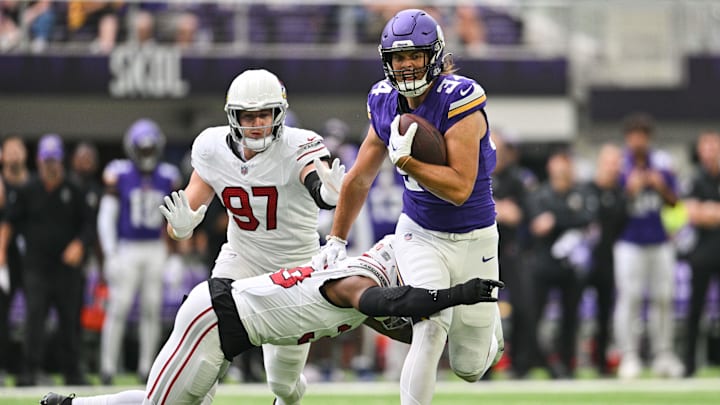 Aug 26, 2023; Minneapolis, Minnesota, USA; Minnesota Vikings tight end Nick Muse (34) runs the ball after a pass reception against Arizona Cardinals safety Jovante Moffatt (38) and linebacker Cameron Thomas (97) during the first quarter at U.S. Bank Stadium.