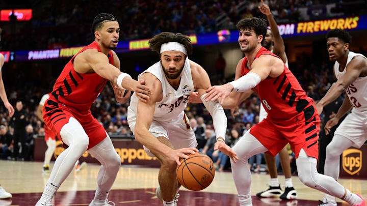 Mar 2, 2025; Cleveland, Ohio, USA; Portland Trail Blazers forward Toumani Camara (33) and forward Deni Avdija (8) go for a loose ball against Cleveland Cavaliers guard Max Strus (1) during the second half at Rocket Arena. Mandatory Credit: Ken Blaze-Imagn Images