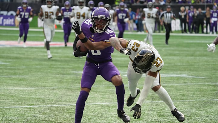 Oct 2, 2022; London, United Kingdom; Minnesota Vikings wide receiver Justin Jefferson (18) carries the ball in the third quarter as New Orleans Saints cornerback Marshon Lattimore (23) defends during an NFL International Series game at Tottenham Hotspur Stadium. The Vikings defeated the Saints 28-25.