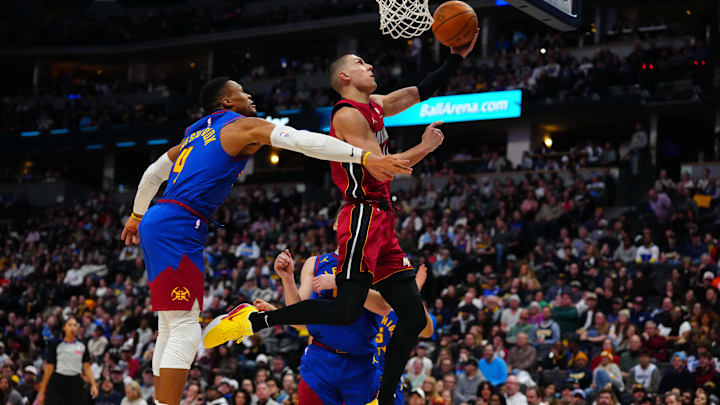 Nov 8, 2024; Denver, Colorado, USA; Miami Heat guard Tyler Herro (14) shoots the ball past Denver Nuggets guard Russell Westbrook (4) in the second half at Ball Arena. Mandatory Credit: Ron Chenoy-Imagn Images Nov 8, 2024; Denver, Colorado, USA; Miami Heat guard Tyler Herro (14) shoots the ball past Denver Nuggets guard Russell Westbrook (4) in the second half at Ball Arena. Mandatory Credit: Ron Chenoy-Imagn Images