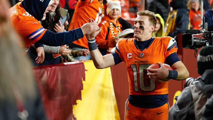 Nov 30, 2025; Landover, Maryland, USA; Denver Broncos quarterback Bo Nix (10) celebrates with fans after the game against the Washington Commanders at Northwest Stadium. 