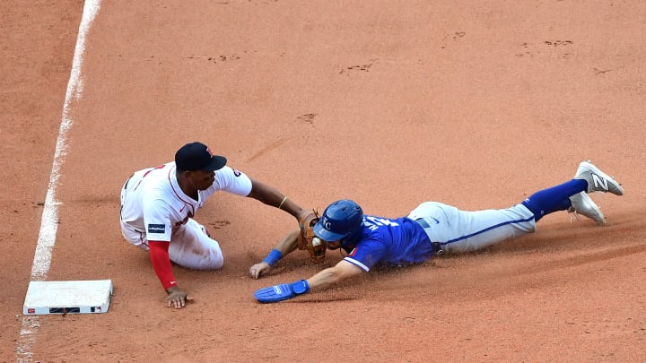 Jul 14, 2024; Boston, Massachusetts, USA; Boston Red Sox third baseman Rafael Devers (11) tags out Kansas City Royals center fielder Garrett Hampson (2) during the ninth inning at Fenway Park. Mandatory Credit: Bob DeChiara-USA TODAY Sports