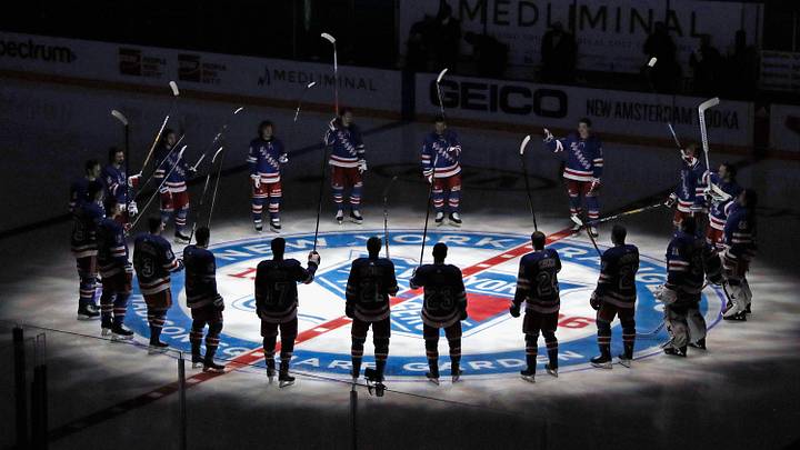 Jan 14, 2021; New York, NY, USA; New York Rangers players huddle around the center ice logo as they prepare for the home opener against the New York Islanders at Madison Square Garden. Jan 14, 2021; New York, NY, USA; New York Rangers players huddle around the center ice logo as they prepare for the home opener against the New York Islanders at Madison Square Garden.