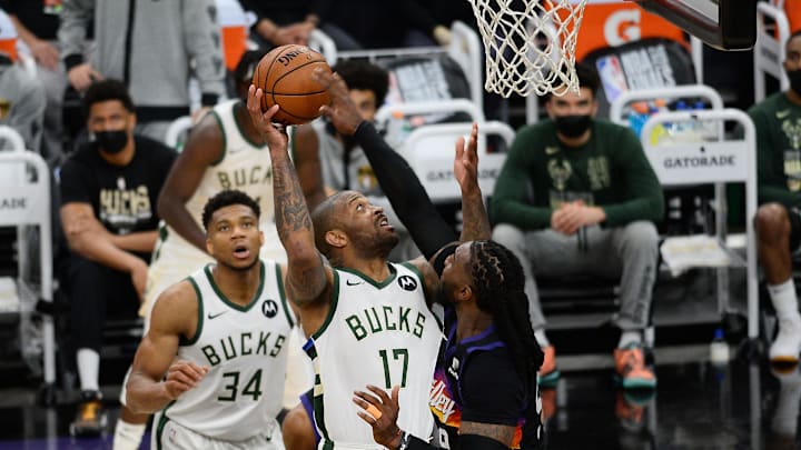 Jul 6, 2021; Phoenix, Arizona, USA; Milwaukee Bucks forward P.J. Tucker (17) moves to the basket agianst Phoenix Suns forward Jae Crowder (99) during the second half in game one of the 2021 NBA Finals at Phoenix Suns Arena. Mandatory Credit: Joe Camporeale-Imagn Images