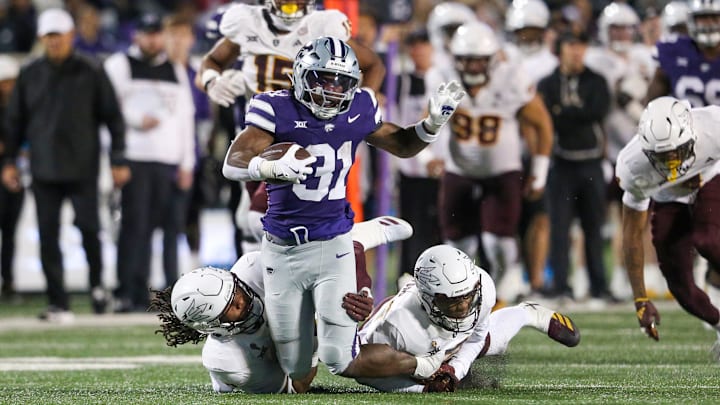 Nov 16, 2024; Manhattan, Kansas, USA; Kansas State Wildcats running back DJ Giddens (31) is tackled by Arizona State Sun Devils defensive lineman Clayton Smith (10) and defensive back Xavion Alford (2) during the third quarter at Bill Snyder Family Football Stadium. Mandatory Credit: Scott Sewell-Imagn Images Nov 16, 2024; Manhattan, Kansas, USA; Kansas State Wildcats running back DJ Giddens (31) is tackled by Arizona State Sun Devils defensive lineman Clayton Smith (10) and defensive back Xavion Alford (2) during the third quarter at Bill Snyder Family Football Stadium. Mandatory Credit: Scott Sewell-Imagn Images